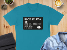 Load image into Gallery viewer, Teal t-shirt with "BANK OF DAD" credit card design.