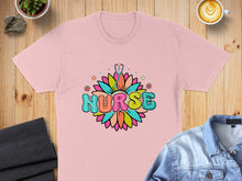 Load image into Gallery viewer, Pink t-shirt with colorful "NURSE" text and floral stethoscope design.