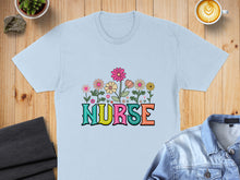 Load image into Gallery viewer, Light blue t-shirt with colorful "Nurse" text surrounded by flowers.