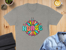 Load image into Gallery viewer, Grey t-shirt with colorful "Nurse" text and floral stethoscope design.