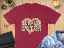 Load image into Gallery viewer, Maroon t-shirt with "Nursing is a work of heart" text and floral design.