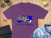 Load image into Gallery viewer, Purple t-shirt with peace sign, heart, and syringe graphic and "Peace love phlebotomy" text.