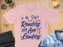Load image into Gallery viewer, Pink t-shirt with "Readers Are Leaders" text and blue bow design.