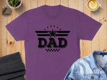 Load image into Gallery viewer, Purple t-shirt with black "DAD" text design featuring wings and stars.