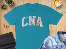 Load image into Gallery viewer, Teal t-shirt with "CNA" in a colorful patchwork applique.