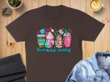 Load image into Gallery viewer, Brown t-shirt with "RCA Resident Care Assistant" text and coffee drinks.
