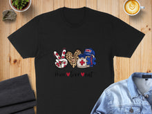Load image into Gallery viewer, Black t-shirt with peace sign, heart, and EMT caduceus emblem.