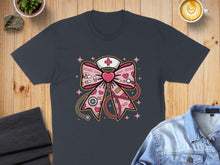 Load image into Gallery viewer, Bow with stethoscope and pink heart design, XOXO pattern, on a dark t-shirt.