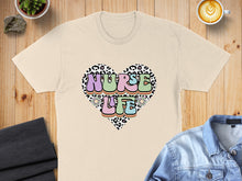 Load image into Gallery viewer, Cream t-shirt with "NURSE LIFE" in a heart shape with leopard print and floral accents.