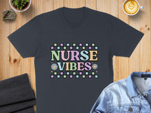 Load image into Gallery viewer, Dark t-shirt with "Nurse Vibes" text and floral accents.