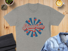 Load image into Gallery viewer, Grey t-shirt with red and blue "America" text and starburst graphic.