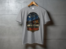 Load image into Gallery viewer, Grey t-shirt with "When the City Sleeps I Transmit" graphic featuring a city skyline at night.