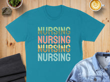 Load image into Gallery viewer, Teal t-shirt with "NURSING" in colorful leopard print text.
