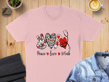 Load image into Gallery viewer, Pink t-shirt with "Peace love scrub" text and medical icons.