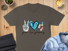 Load image into Gallery viewer, T-shirt with "peace love pharmacy" text and peace sign heart.