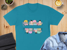 Load image into Gallery viewer, Split design of colorful pencils with bows and flowers on a teal t-shirt.