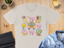 Load image into Gallery viewer, School-themed graphic with a bus, globe, lightbulb, and crayons on a t-shirt.