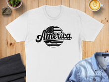 Load image into Gallery viewer, White t-shirt with "America EST. 1776" text and an American flag graphic.