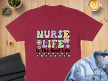 Load image into Gallery viewer, Burgundy t-shirt with colorful "Nurse Life Is The Best Life" text and flowers.