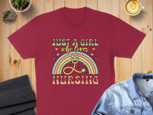 Load image into Gallery viewer, Maroon t-shirt with "Just a girl who loves nursing" text and rainbow stethoscope graphic.
