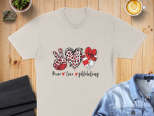 Load image into Gallery viewer, Peace love phlebotomy graphic on tan t-shirt with heart and syringe.
