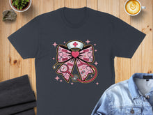 Load image into Gallery viewer, Pink bow with stethoscope, nurse hat, and XOXO pattern on dark t-shirt.