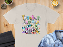 Load image into Gallery viewer, T-shirt with colorful crayon graphic and "Teacher You Are" text.