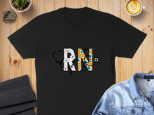 Load image into Gallery viewer, Black t-shirt with white RN lettering incorporating stethoscope and eye graphic.