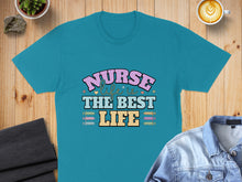 Load image into Gallery viewer, Turquoise t-shirt with "Nurse is the best life" text and colorful syringe graphic.