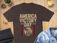 Load image into Gallery viewer, Brown t-shirt with "America Victory Day May 8" and a flag graphic.