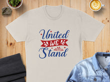 Load image into Gallery viewer, Beige t-shirt with "United We Stand" text and American flag accents.
