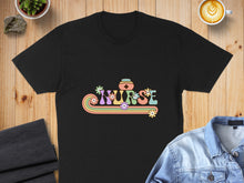 Load image into Gallery viewer, Black t-shirt with colorful "NURSE" text featuring flowers and a stethoscope.