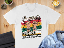 Load image into Gallery viewer, Juneteenth t-shirt with chained fists and "Celebrating Black Freedom" text.