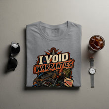 Load image into Gallery viewer, Gray t-shirt with "I VOID WARRANTIES" graphic featuring electronics repair.