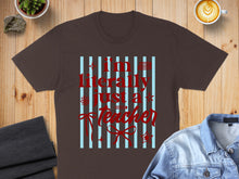 Load image into Gallery viewer, Brown t-shirt with "I'm literally just a teacher" text in red on blue stripes.