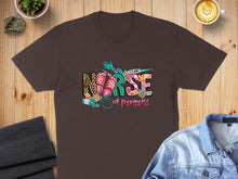 Load image into Gallery viewer, Brown t-shirt with "Nurse in Progress" text and medical icons.