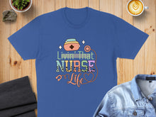 Load image into Gallery viewer, Blue t-shirt with "Livin' That Nurse Life" text and stethoscope graphic.
