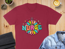 Load image into Gallery viewer, Burgundy t-shirt with "Nurse" in colorful, floral lettering and a stethoscope.