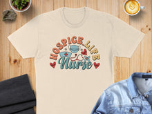 Load image into Gallery viewer, T-shirt featuring "Hospice Nurse" text with medical graphics.