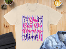 Load image into Gallery viewer, Cream t-shirt with pink and purple text reading "You Can Do Hard Things".