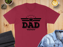 Load image into Gallery viewer, Burgundy t-shirt with "Dad" text and star graphic, on a wooden surface.