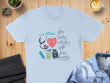 Load image into Gallery viewer, Light blue t-shirt with medical graphic and "she works willingly with her hands Proverbs 31:13" text.