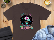 Load image into Gallery viewer, Brown t-shirt with colorful graphic of a Black nurse with butterflies, text "Nursing is a work of heart."