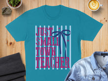 Load image into Gallery viewer, Turquoise t-shirt with "Just Small Town Teacher" text and blue bow.