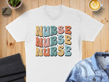 Load image into Gallery viewer, White t-shirt with "NURSE" in colorful retro lettering.