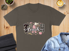 Load image into Gallery viewer, T-shirt with "TEACH" text, apple, pencil, and books design.