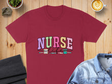 Load image into Gallery viewer, Burgundy t-shirt with "Nurse Life" text and medical icons.