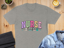 Load image into Gallery viewer, Gray t-shirt with colorful "Nurse Life" text and medical icons.