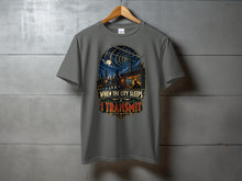 Load image into Gallery viewer, Gray t-shirt with "When the City Sleeps I Transmit" text and cityscape graphic.