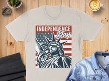 Load image into Gallery viewer, Statue of Liberty and American flag graphic on tan t-shirt.